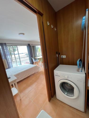a room with a bed and a washing machine at Estúdio Frente Mar in Horta