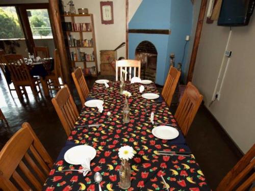 a table with a table cloth with flowers on it at Port St Johns River Lodge in Port St Johns