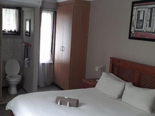 a bedroom with a bed with a tray on it at Port St Johns River Lodge in Port St Johns