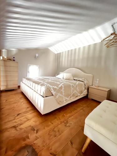 a bedroom with a large bed and a skylight at Da Ale e De in Isolabona