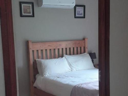 a bedroom with a bed with white pillows at Port St Johns River Lodge in Port St Johns