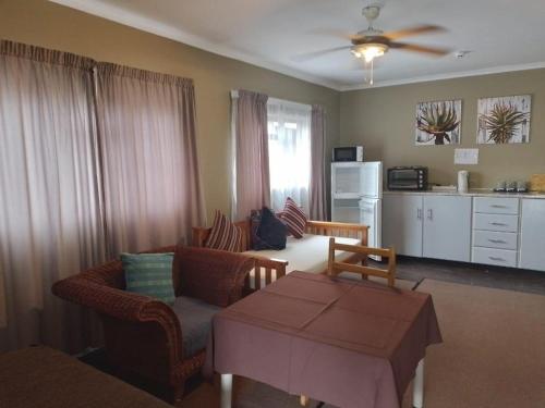 a living room with a couch and a table at Port St Johns River Lodge in Port St Johns