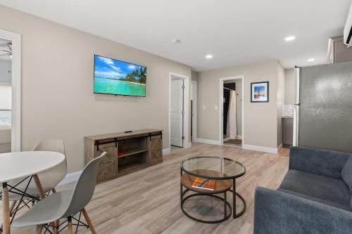 a living room with a couch and a table at Fully Renovated Steps to Beach The Americana in Hampton