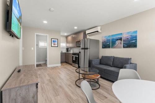 a living room with a couch and a table at Fully Renovated Steps to Beach The Americana in Hampton