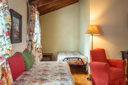 a small room with a bed and a chair at Hotel Sao Joao De Deus by RIDAN Hotels in Elvas