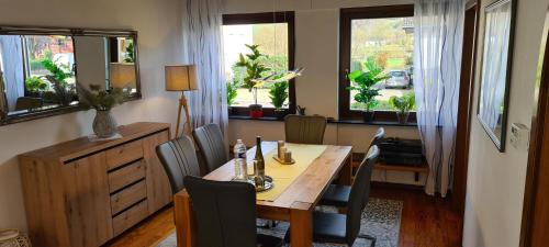 a dining room with a wooden table and chairs at Haus Tildchen in Ayl