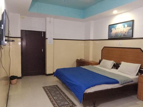 a bedroom with a bed and a television in it at Hotel Swagat Bhubaneswar in Bhubaneshwar