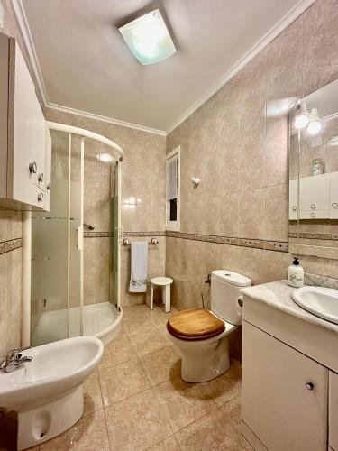 a bathroom with a toilet and a sink and a tub at Del Valle 1 in Cudillero