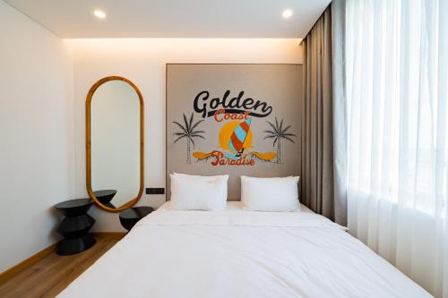 a bedroom with a bed and a sign on the wall at PĀMA Boutique Hotel & Bistro in Da Nang