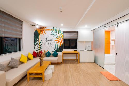 a living room with a couch and a table at PĀMA Boutique Hotel & Bistro in Da Nang