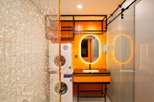 a bathroom with a washing machine and a sink at PĀMA Boutique Hotel & Bistro in Da Nang
