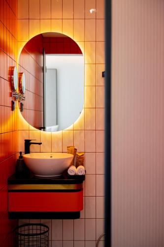 a bathroom with a sink and a mirror at PĀMA Boutique Hotel & Bistro in Da Nang
