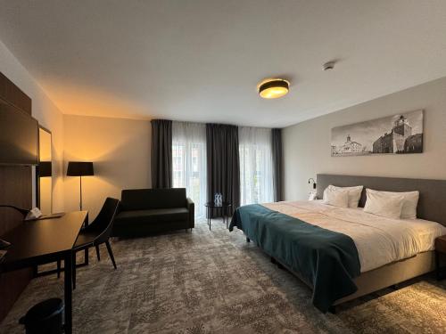a hotel room with a bed and a desk at Focus Hotel Premium Lublin in Lublin