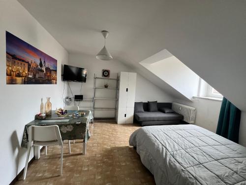 a bedroom with a bed and a desk and a couch at SWEET APT Piazza Statuto 9 nel pieno CENTRO di TORINO in Turin
