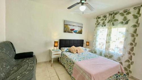 a bedroom with a bed and a chair and a window at MEDDAYS APARTAMENTO MONTEMAR in Miami Platja