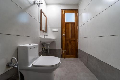a bathroom with a toilet and a sink at WINTEL WILD in Vālpārai
