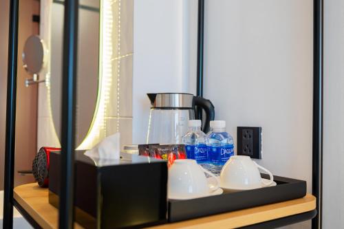 a table with a coffee maker and bottles of water at PĀMA Boutique Hotel & Bistro in Da Nang