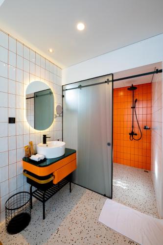 a bathroom with a sink and a mirror at PĀMA Boutique Hotel & Bistro in Da Nang