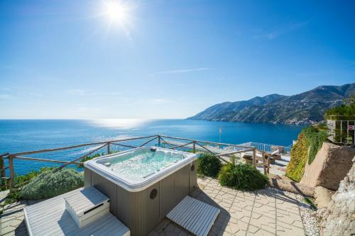 a hot tub with a view of the ocean at Villa Venera - pool, jacuzzi & breathtaking view in Maiori