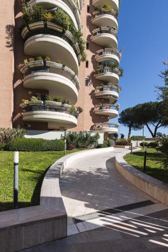 a large apartment building with balconies on a street at Galo Luxury House in Rome