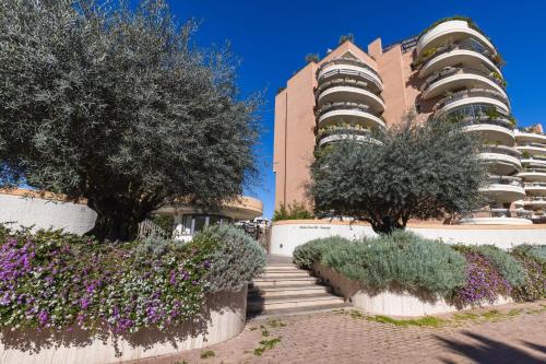 a building with trees and flowers in front of it at Galo Luxury House in Rome