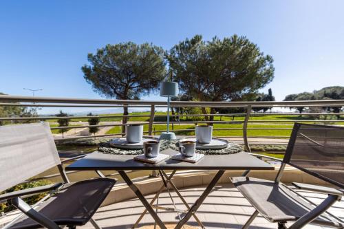 a table and chairs on a deck with coffee cups at Galo Luxury House in Rome