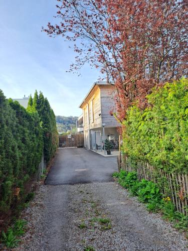 a driveway leading to a house with a fence at Schöne Ferienwohnung in Feldkirch