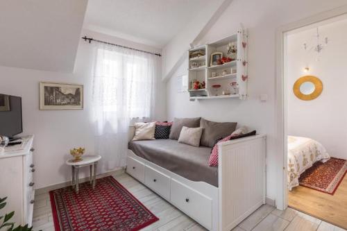 a small bedroom with a bed and a window at Apartments Petra in Split