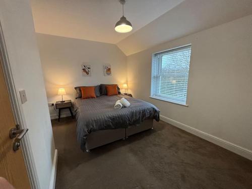 a bedroom with a bed and a window at 3 Cherry Tree Cottages in Stock