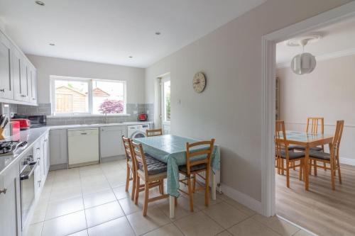 a kitchen and dining room with a table and chairs at GuestReady - A charming place near Golf Centre in Dublin