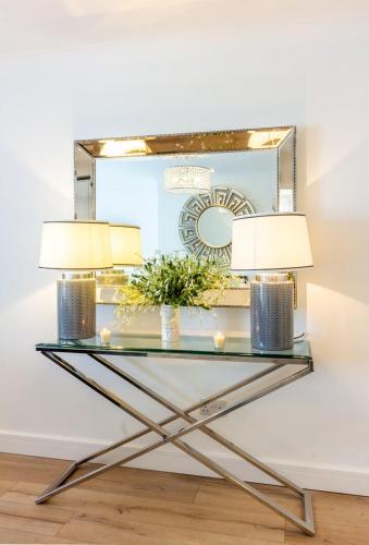 a console table with two lamps and a mirror at GuestReady - Impressionante Flat com Vista Terraço in Malahide