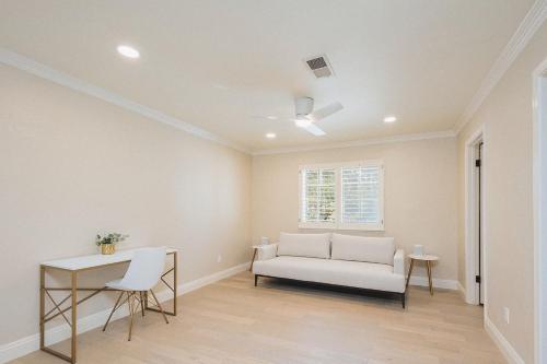 a living room with a couch and a table at Casteel - 4,500 sq-ft retreat with a pool and hot tub in the middle of wine country! in Templeton