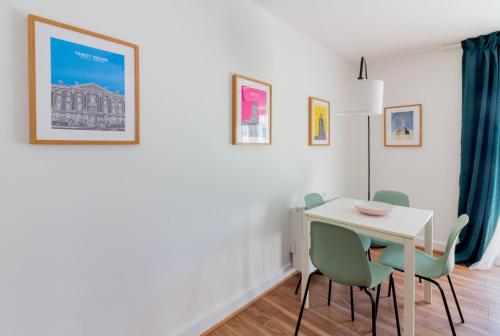 a dining room with a white table and green chairs at GuestReady - Modern stay by Pheonix Park in Dublin