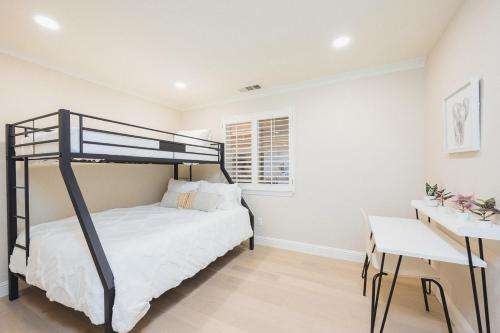a bedroom with a bunk bed and a desk at Casteel - 4,500 sq-ft retreat with a pool and hot tub in the middle of wine country! in Templeton