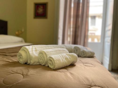 a group of towels sitting on top of a bed at Umberto House Catania in Catania