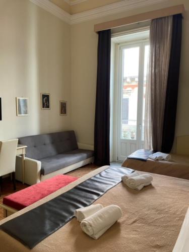 a living room with a bed and a couch at Umberto House Catania in Catania