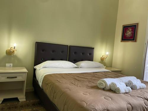 a bedroom with a bed with two towels on it at Umberto House Catania in Catania