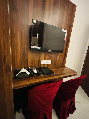 a desk with a computer monitor on a wall at Airport Hotel Relax Inn in Nagpur