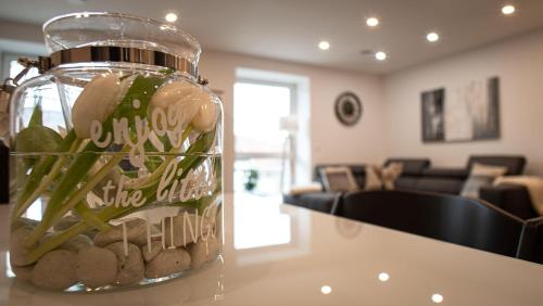 a jar filled with rocks on a table in a living room at Ferienwohnungen Im Kimmelreich in Irsch