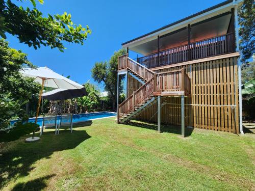 a house with a large deck and a swimming pool at OXLEY Mineral Pool & Private Home suburbanSTAY in Brisbane