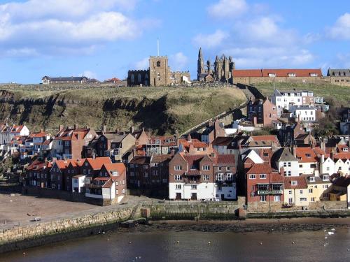 a town with a castle on top of a hill at Storrbeck Guest House in Whitby