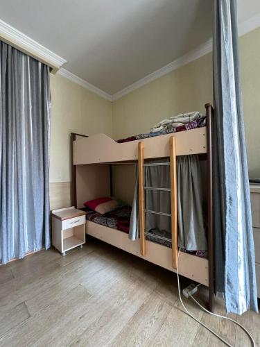 a bedroom with two bunk beds in a room at TJ+ Hostel in Batumi