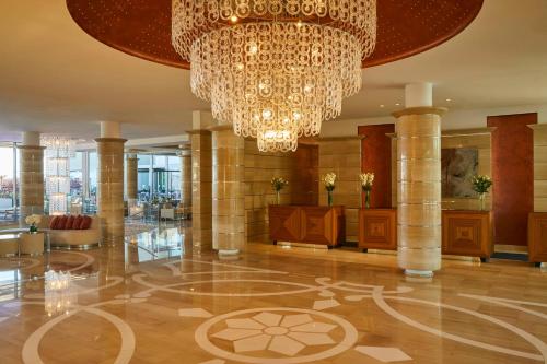 a large lobby with a chandelier in a building at Kempinski Hotel Adriatic Istria Croatia in Savudrija