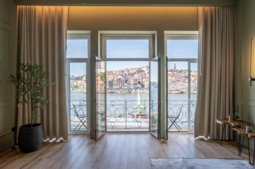 a living room with large windows and a view of the water at Riverside Oasis by LovelyStay in Vila Nova de Gaia