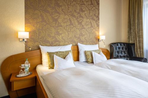 En eller flere senge i et værelse på Gasthaus Assenmacher