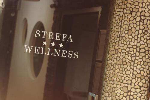 a sign that says strefa wellness on a glass door at Centrum Green Hill Business & SPA in Wisła