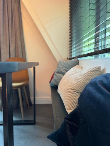 a room with a bed and a table and a chair at A - (frame) - Like A dream in Durbuy