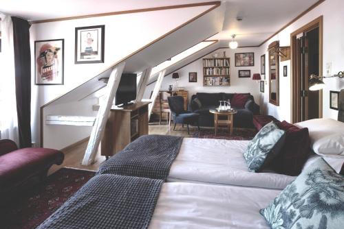 a bedroom with a bed and a living room at Hotell Gästis in Varberg