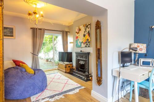 a living room with a blue couch and a fireplace at GuestReady - Charming House in East Wall in Dublin