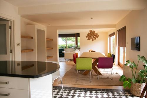 a kitchen and dining room with a table and chairs at GuestReady - Epitome of Luxury near Shankill Beach in Dublin